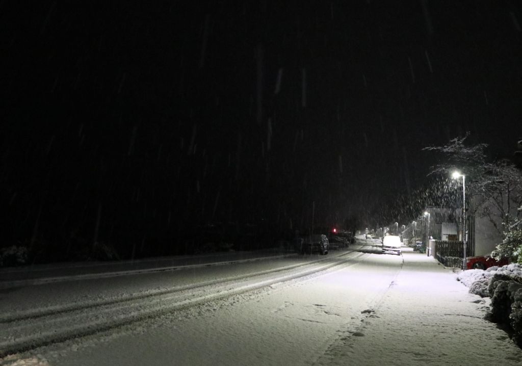 A photo of a snowy street in Lochcarron in Scotland