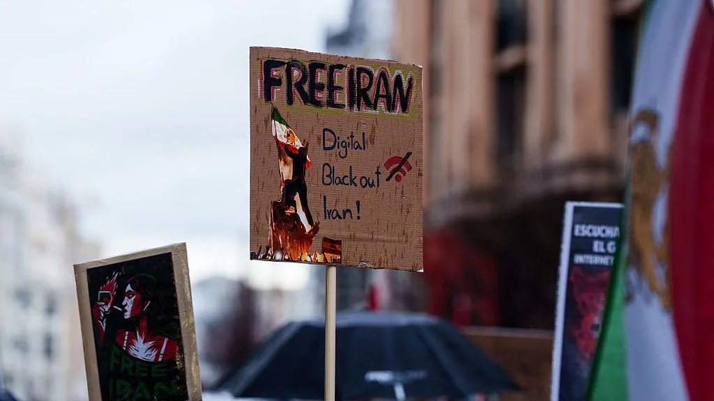 image of a cardboard protest sign, reading 