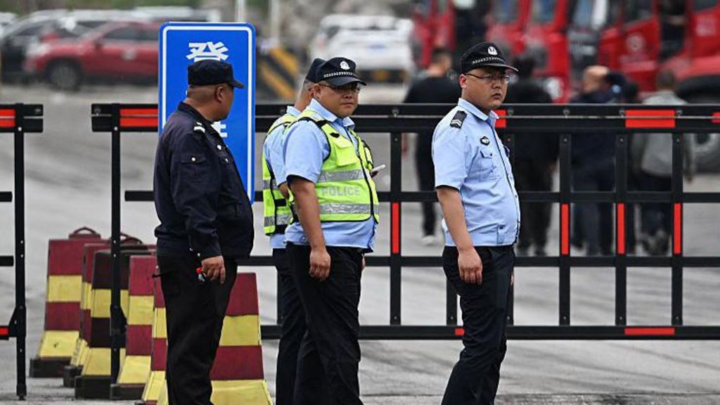 Police guard the road outside the Liushenyu coal mine, where an explosion killed dozens in Qinyuan county, in China's northern Shanxi province on May 24, 2026.