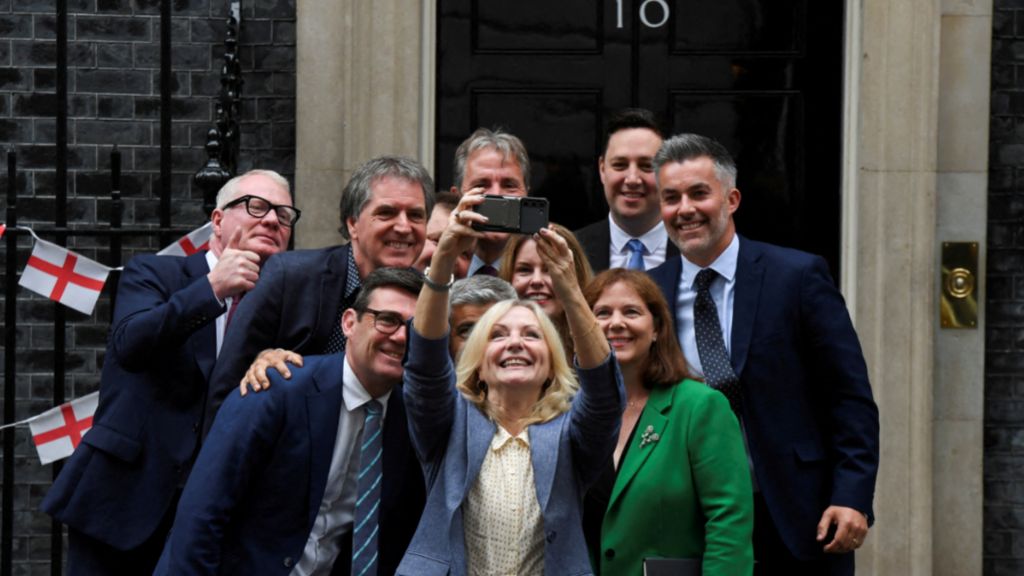 Mayors from across England take a picture of themselves outside the door of 10 Downing Street