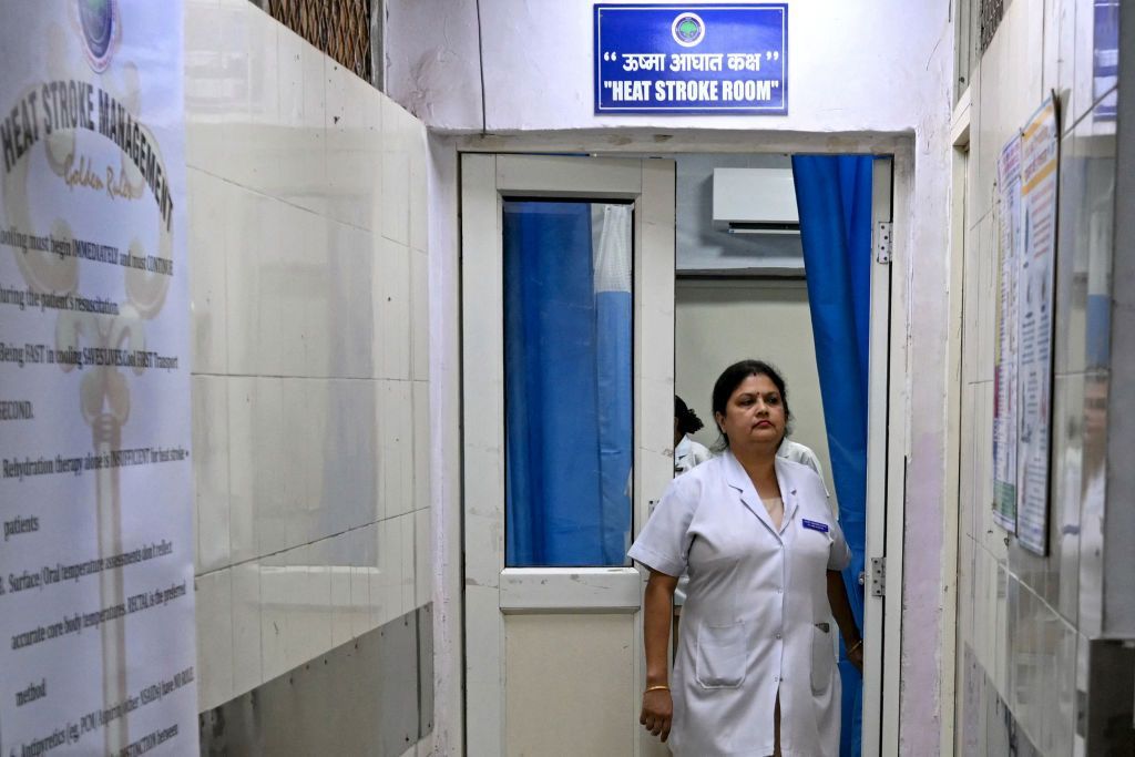 A medical staff walks out of a heat stroke room at the Ram Manohar Lohia hospital in New Delhi on May 30, 2024. In Delhi's Ram Manohar Lohia hospital, a specialised unit is busy treating patients with heat-related illnesses. Equipped with immersion ice baths, the unit has treated eight heat-struck patients in the past week. (Photo by Arun SANKAR / AFP) (Photo by ARUN SANKAR/AFP via Getty Images)