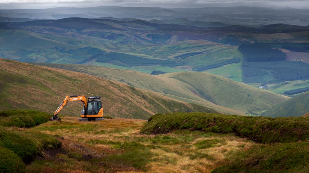 A digger at work high on a hill in Northumberland