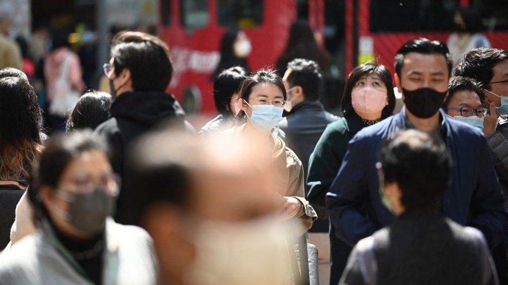 People wear masks on public transportation in Hong Kong