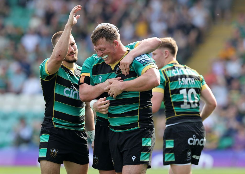 Alex Waller is congratulated by fellow Northampton players after his try