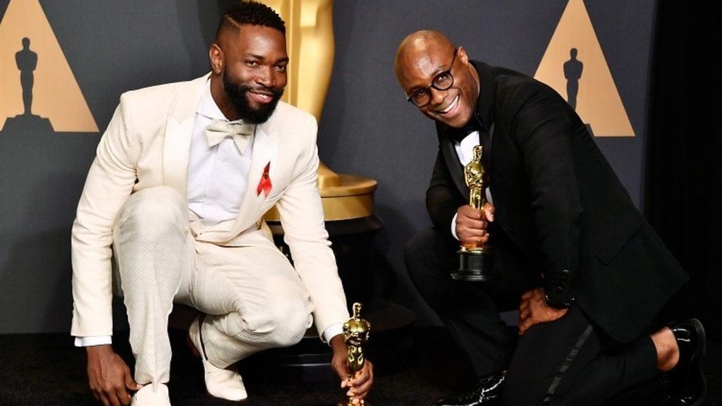 Tarell Alvin McCraney and Barry Jenkins holding their Oscars