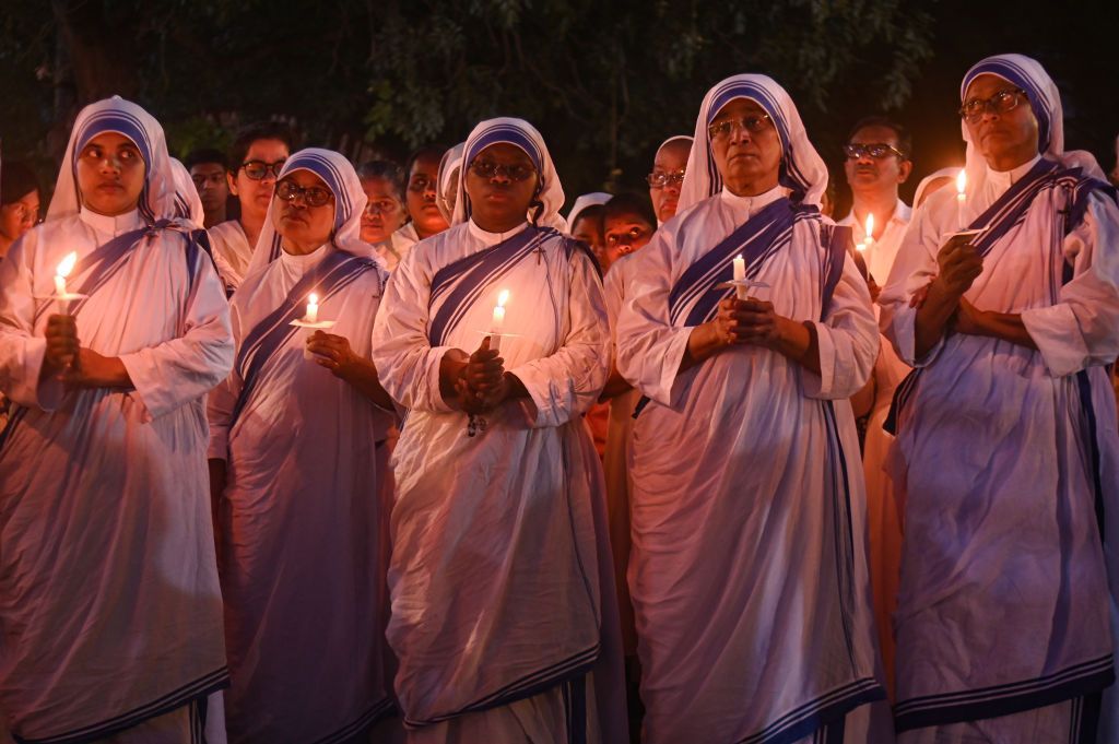 Indian Christian nuns are holding candles during a candlelight vigil outside a church to mark the one-year anniversary of the violent clashes that began on May 3, 2023, between the Meiteis and the Kuki-Zo ethnic groups in the northeastern state of Manipur, in New Delhi, India, on May 3, 2024. (