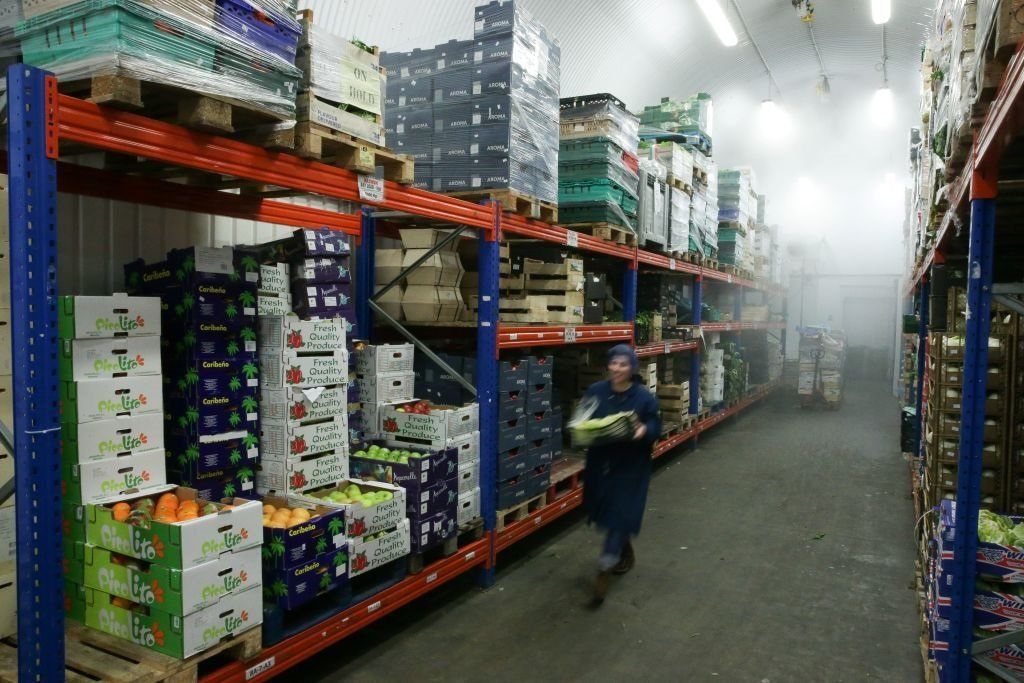 Workers prepare boxes of fresh fruit and vegetables ahead of distribution from a London warehouse
