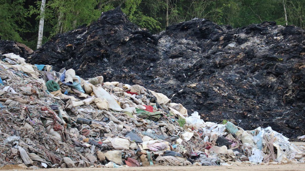Piles of burned rubbish at Straits Mill waste site, Braintree