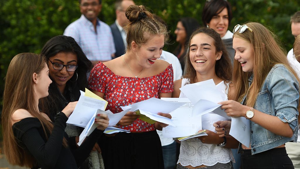Girls smiling as they hold their results