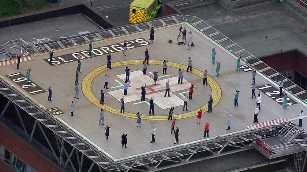People on a helipad clapping