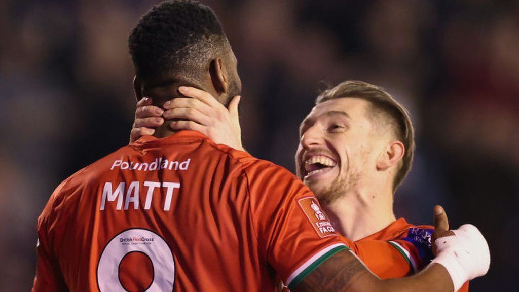 Tom Knowles helps Jamille Matt celebrate his first Walsall goal of the season