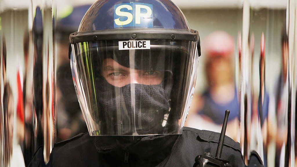 Police officer in riot helmet