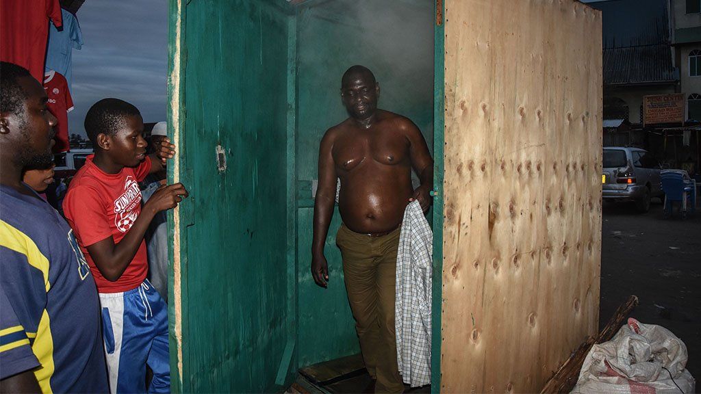 A man leaves a steam inhalation booth in Dar es Salaam, Tanzania, on 22 May, 2020