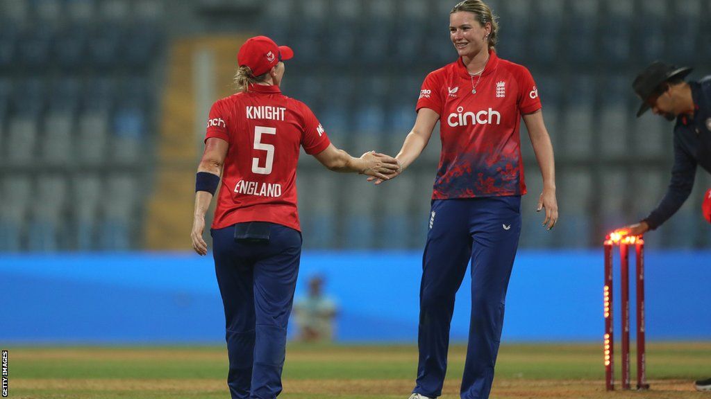 Heather Knight (left) celebrates a wicket with Lauren Bell