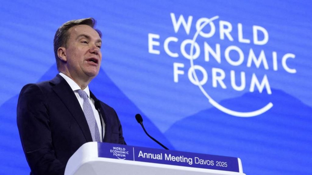 Borge Brende speaking on stage at Davos in January. He is wearing a suit and standing in front of a background which says "World Economic Forum".