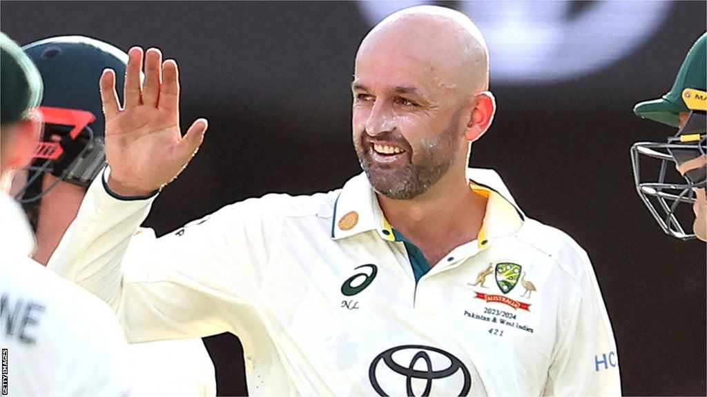 Nathan Lyon high-fives a teammate while on Australia duty