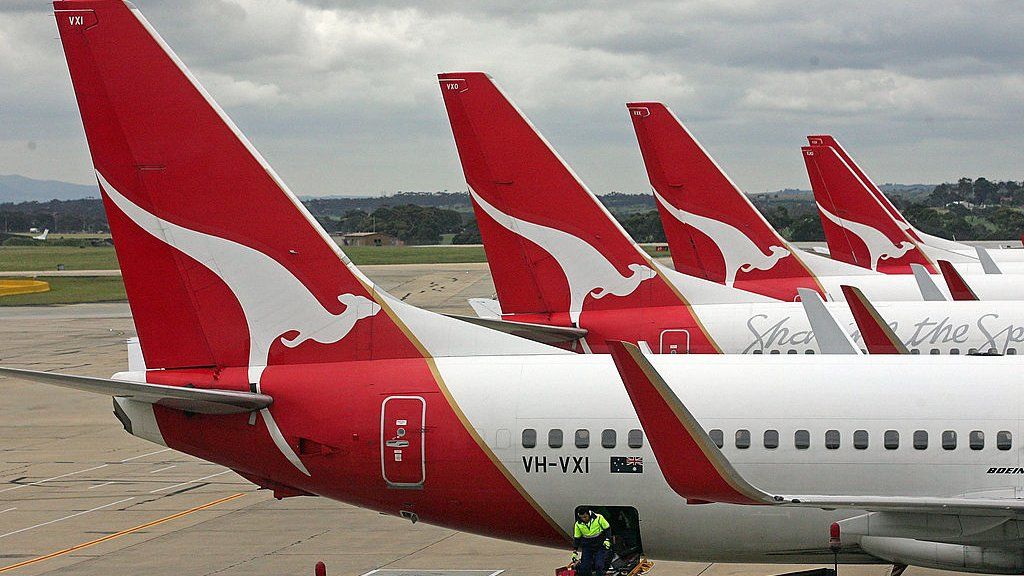 A mixture of Qantas aircraft parked on one of the three runways in Sydney, Australia.