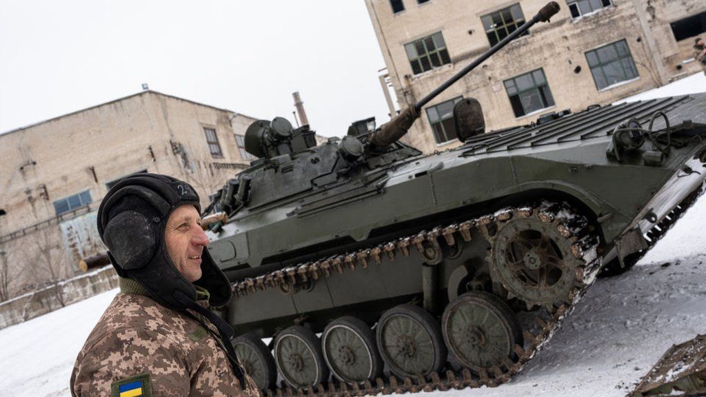 A Ukrainian soldier and a tank, January 2022