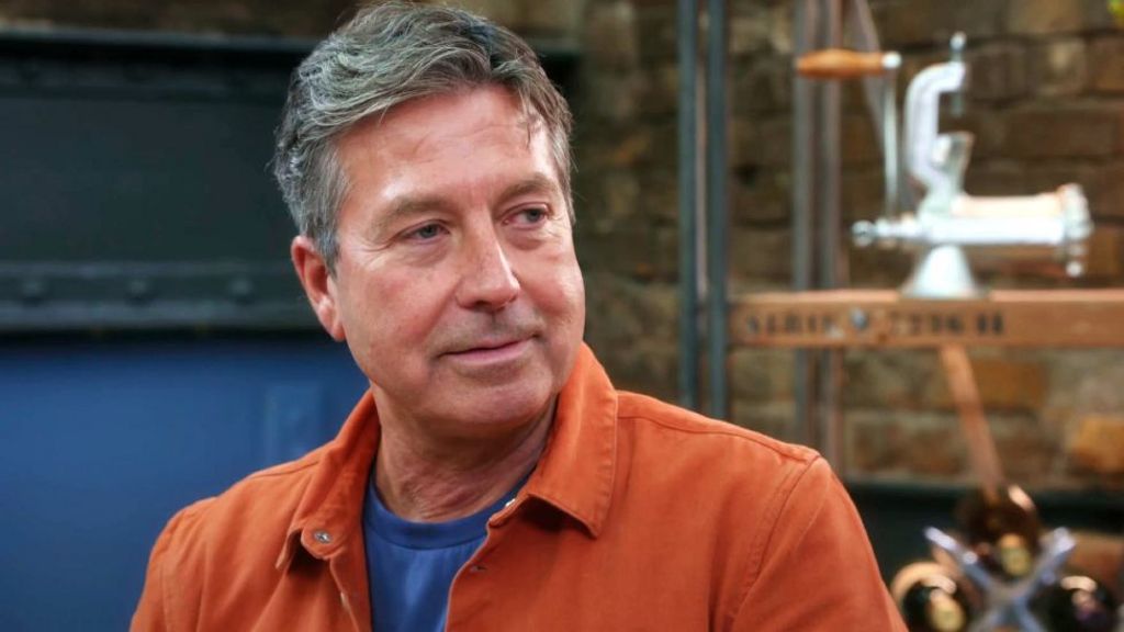 John Torode pictured on series 19 of Masterchef, wearing an orange shirt