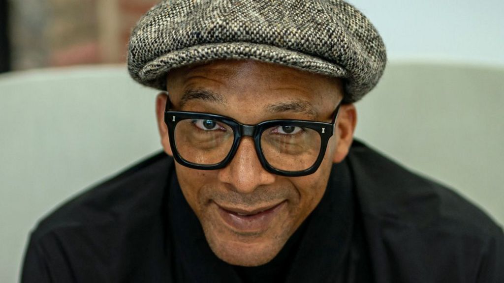 Jay Blades wearing a cap and looking at the camera