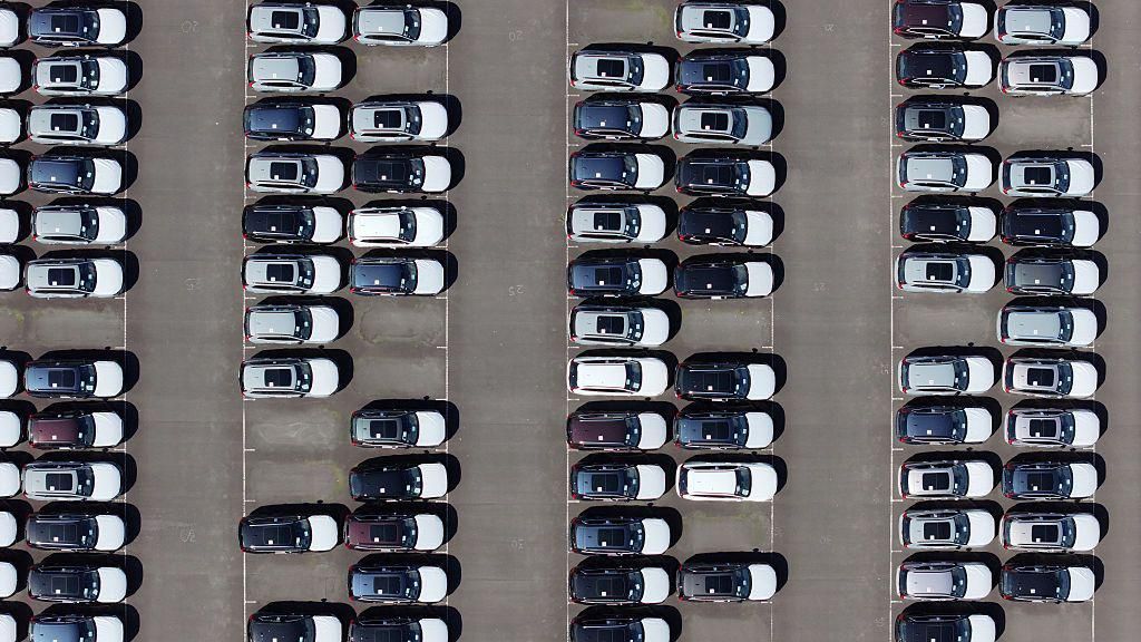 An aerial view of whit and black imported new cars on the quayside of Alexandra Dock at Grimsby Port.