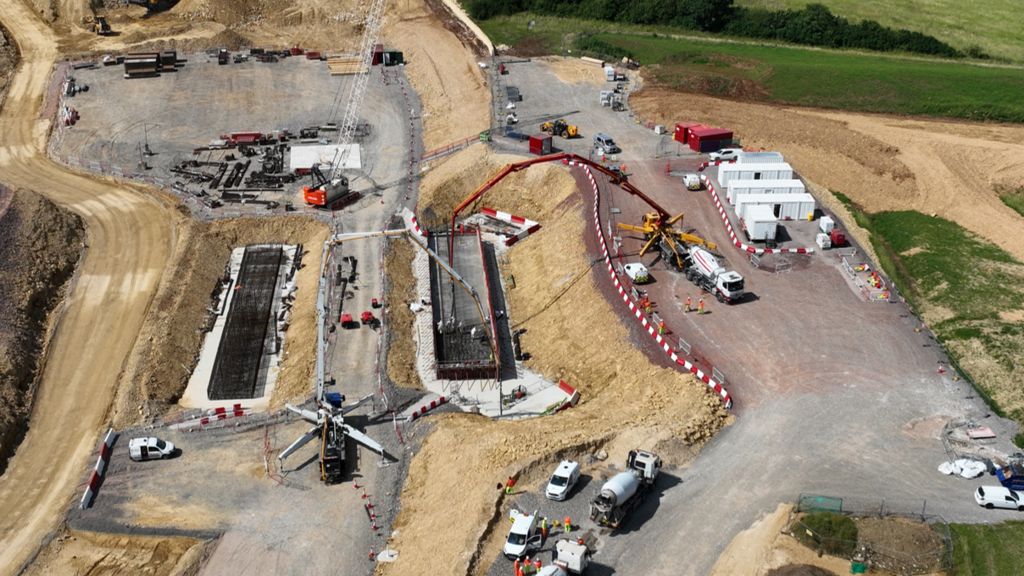 A417 missing link project aerial shot. Construction vehicles and machinery can be seen at the site. 