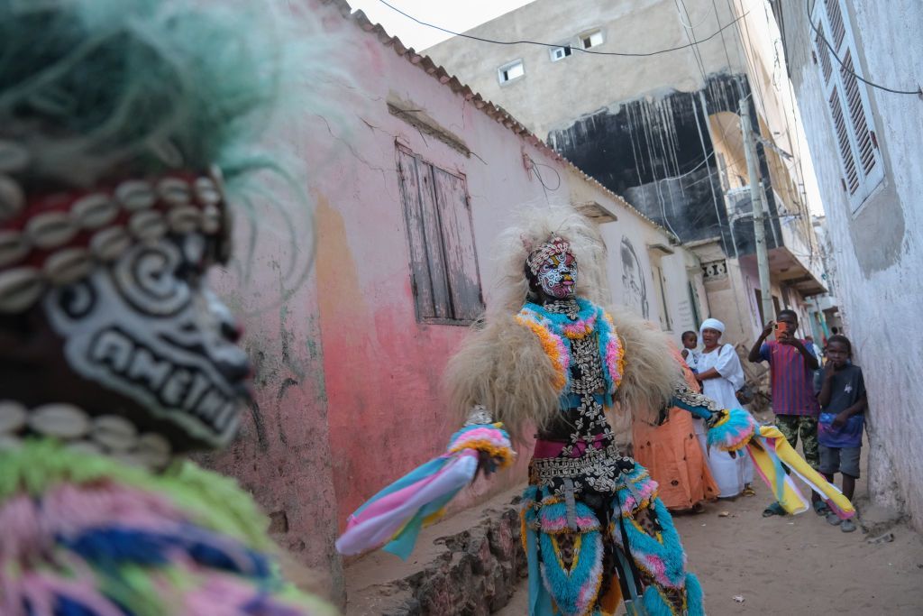 A performer dances in a traditional Simb costume during a cultural show at Ngor in Dakar, on 12 August 2024