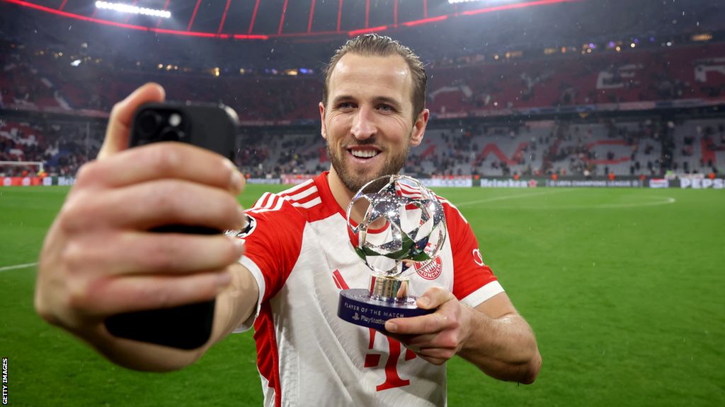 Harry Kane poses for a photo with the player of the match award after helping Bayern Munich beat Lazio in the Champions League