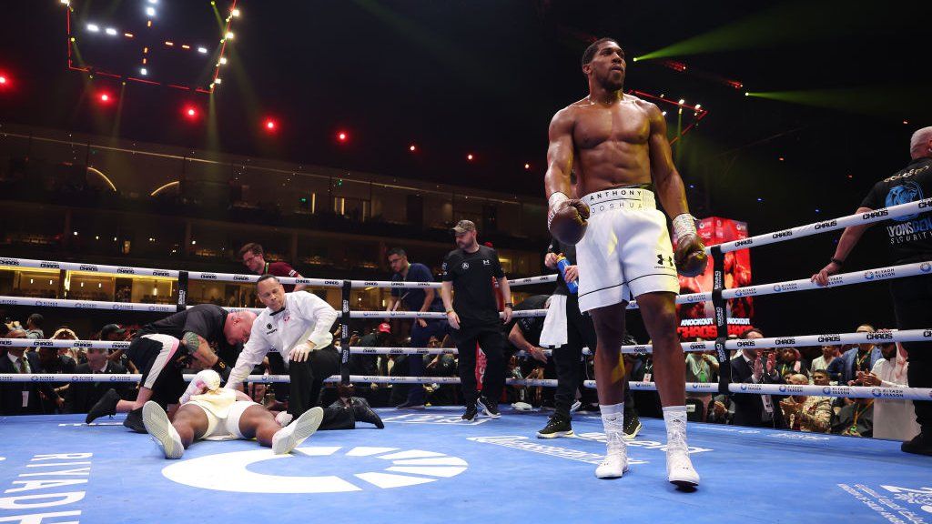 Anthony Joshua walks away from a knocked down Francis Ngannou