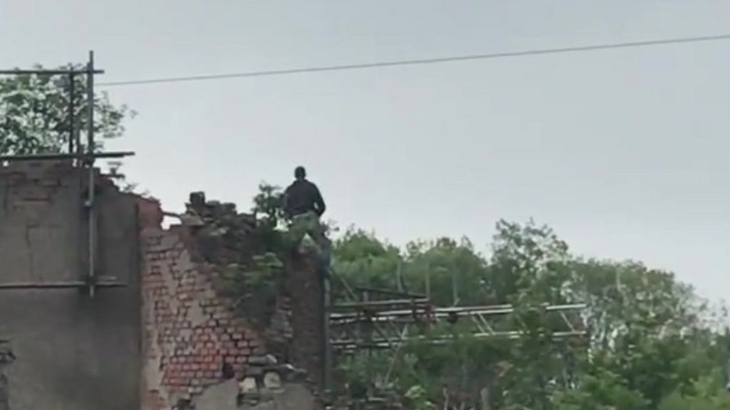 Man on top of roof