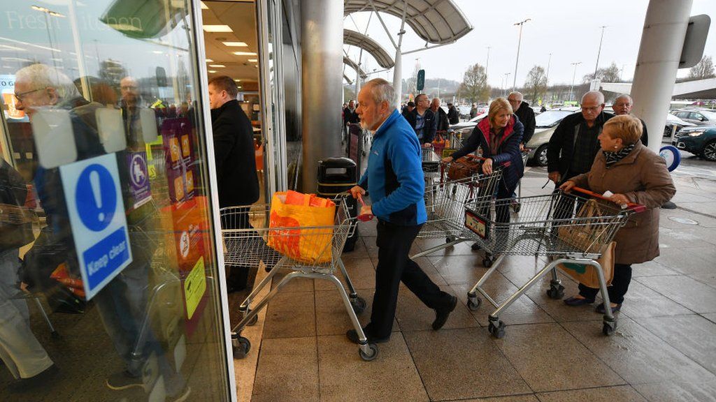 Shoppers queue to enter Sainsbury's