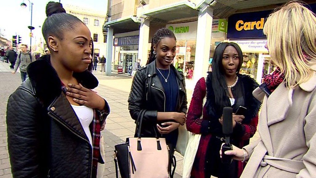 Young women talk to reporter