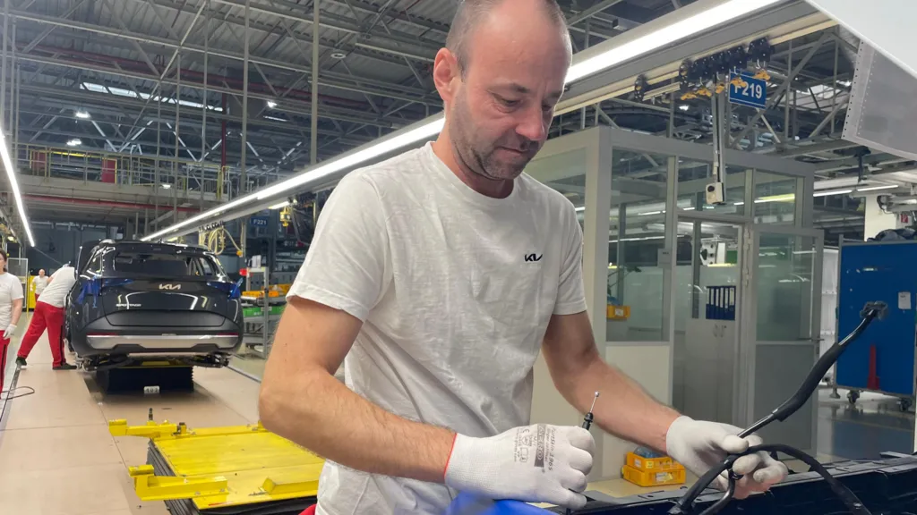 Kia assembly line worker Marcel Pukhon helping to build a car on a assembly line