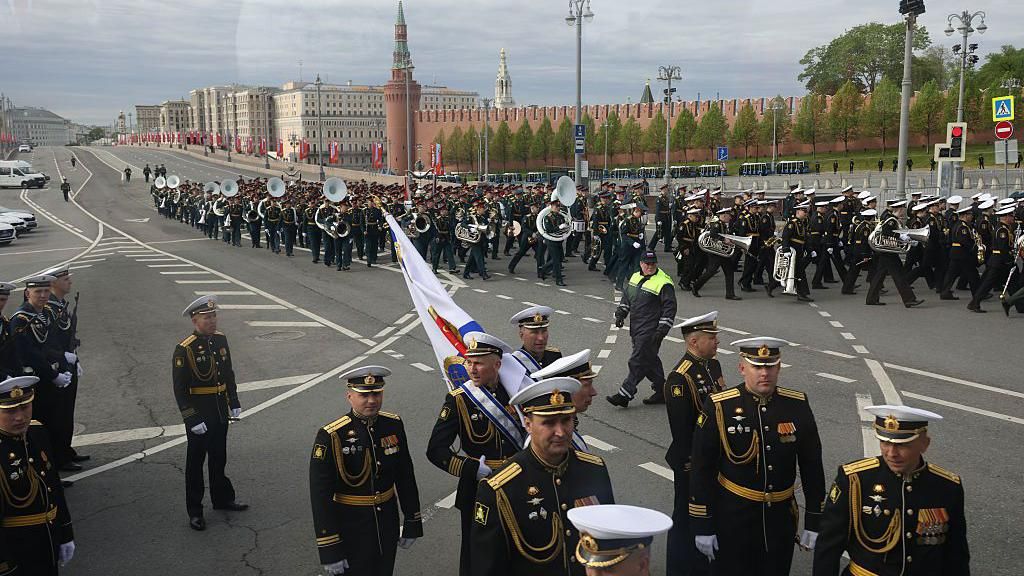 A marching band parades through the streets of Moscow