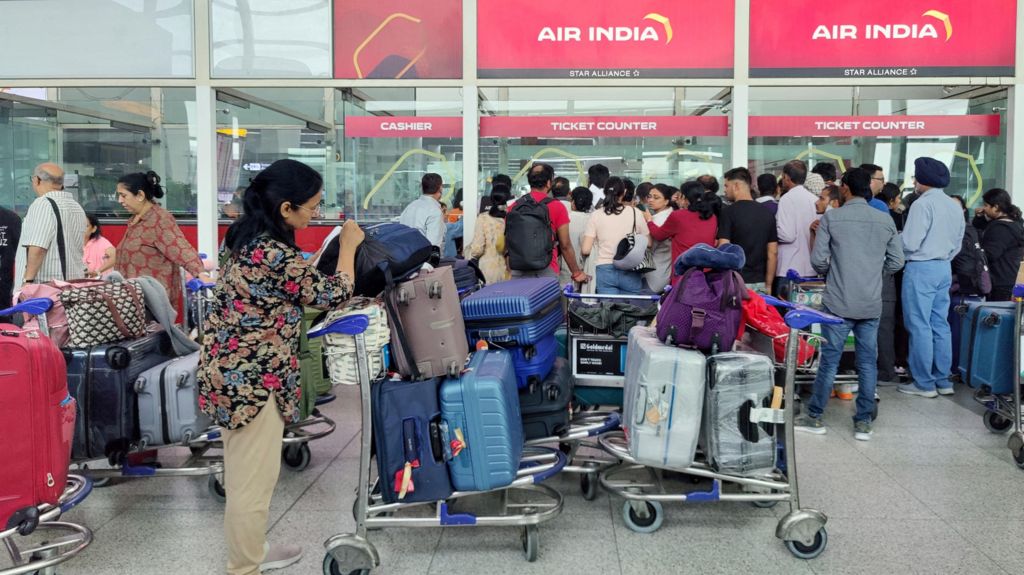 Queues at Delhi airport amid cancellations and delays.