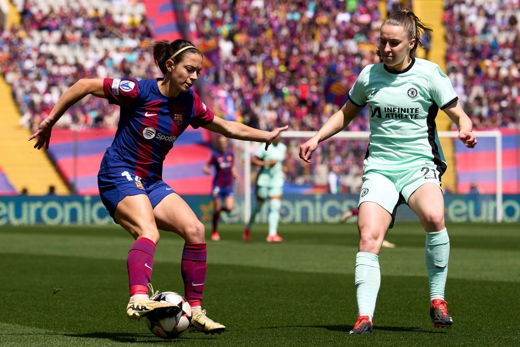 Aitana Bonmati and Niamh Charles challenge for the ball in Barcelona