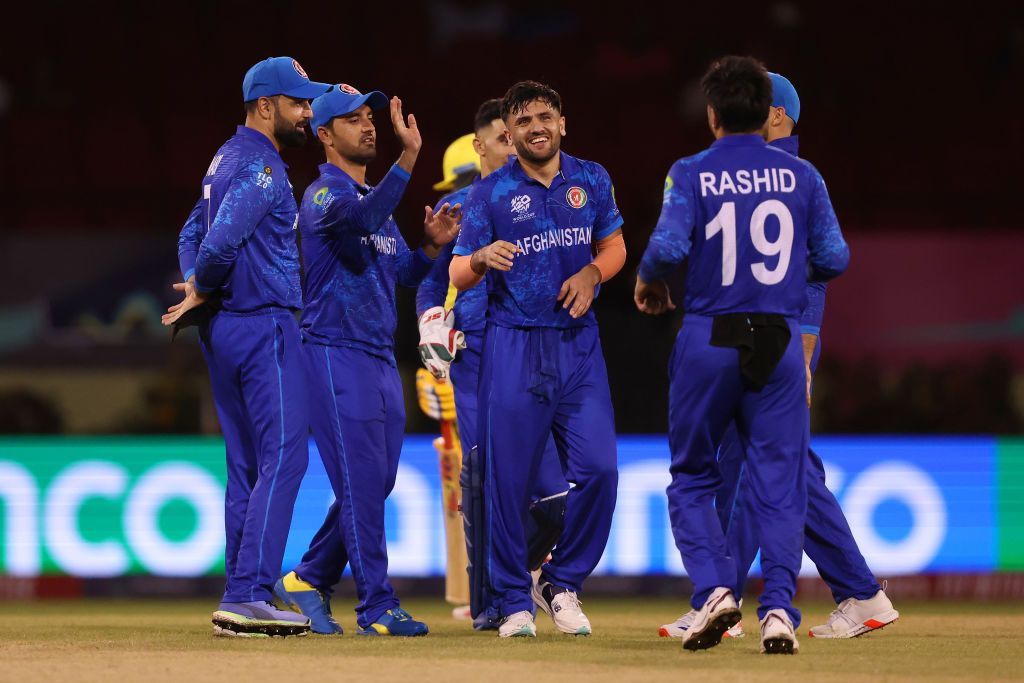 Fazalhaq Farooqi celebrating a wicket with his team-mates