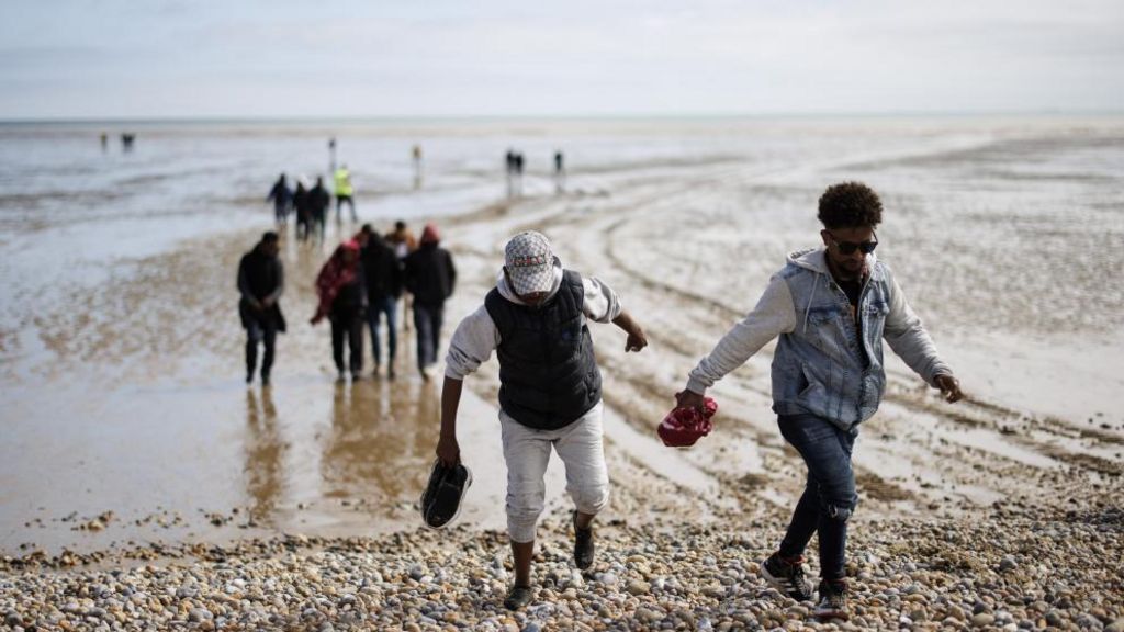 Rescued migrants landing on a beach in Kent