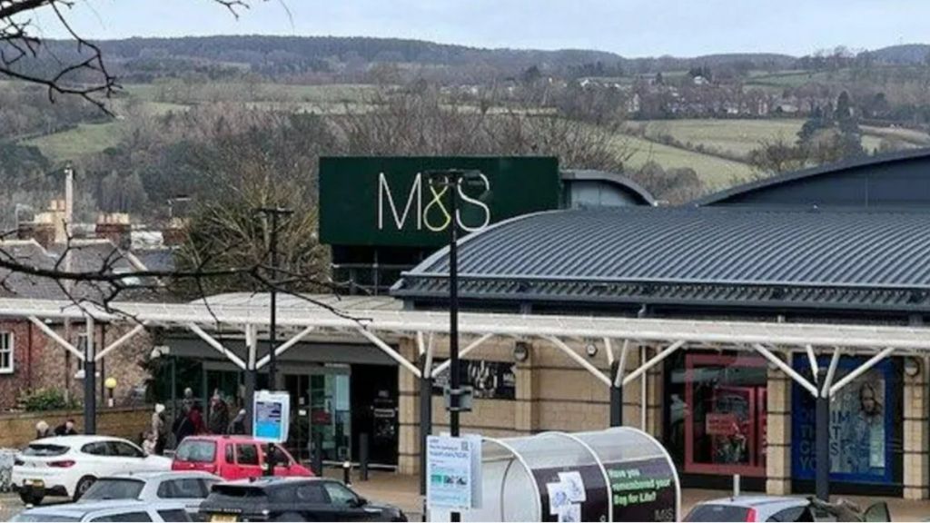 The outside of the M&S in Hexham with hills behind 
