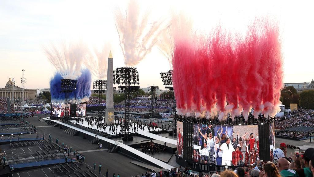 Smoke is released in the colours of the French flag at Place de la Concorde