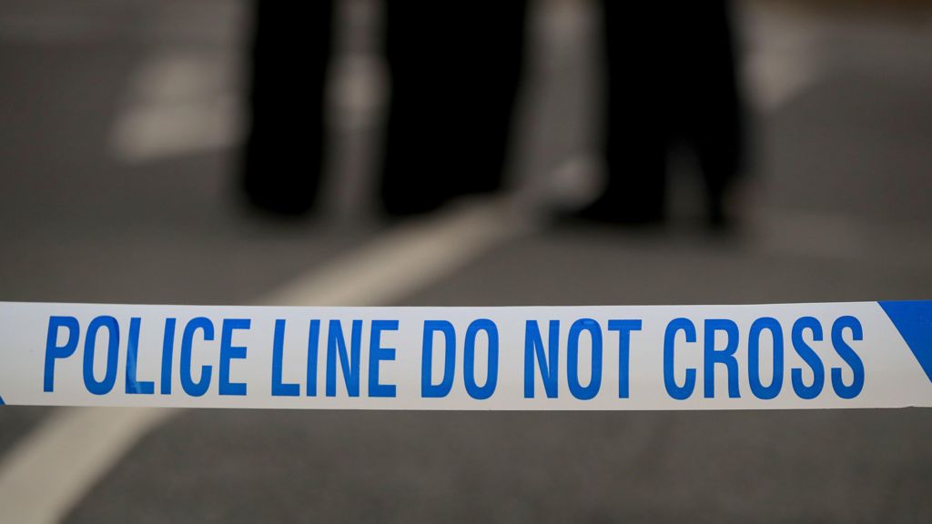 White and blue police tape, reading: "Police line do not cross".