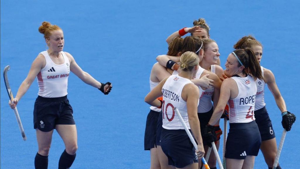 Laura Roper of Britain celebrate with teammates their first goal.