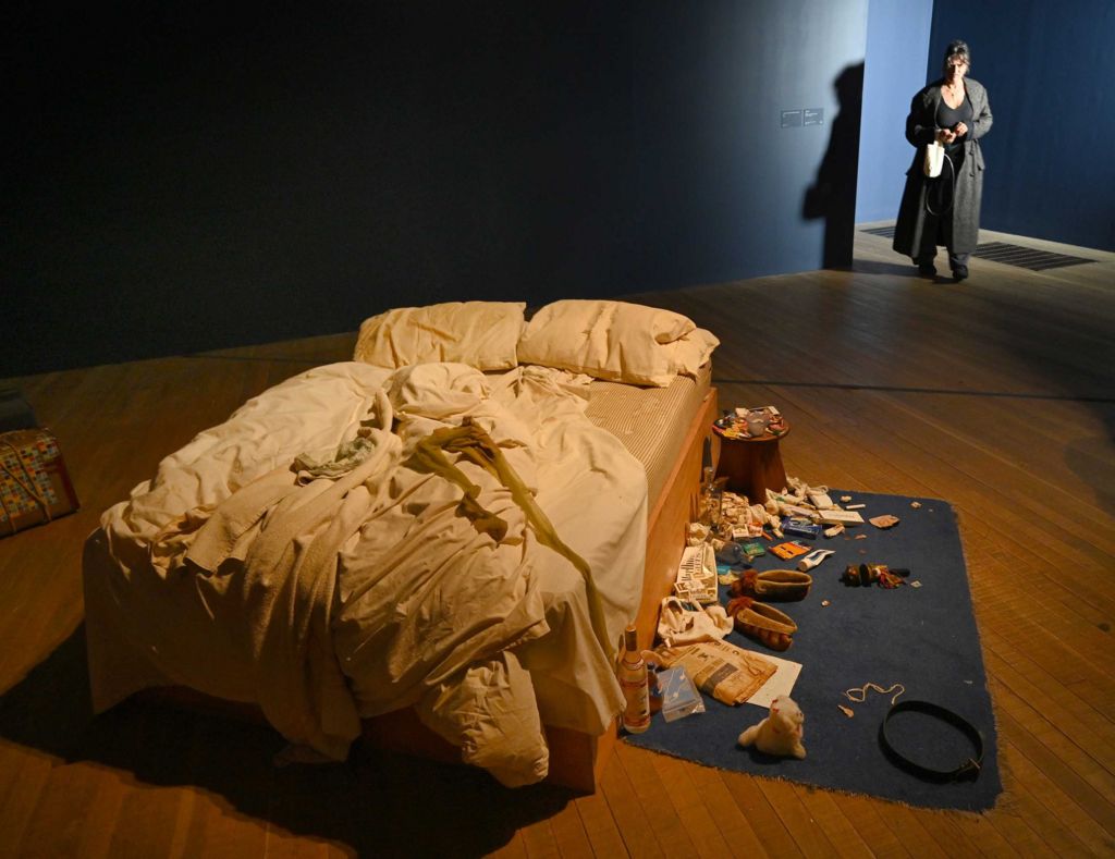 Dame Tracy Emin stands near her artwork, My Bed, which is unmade and has things on the floor including slippers, underwear, a newspaper and underwear, ahead of the new exhibition, Tracey Emin: A Second Life at London's Tate Modern