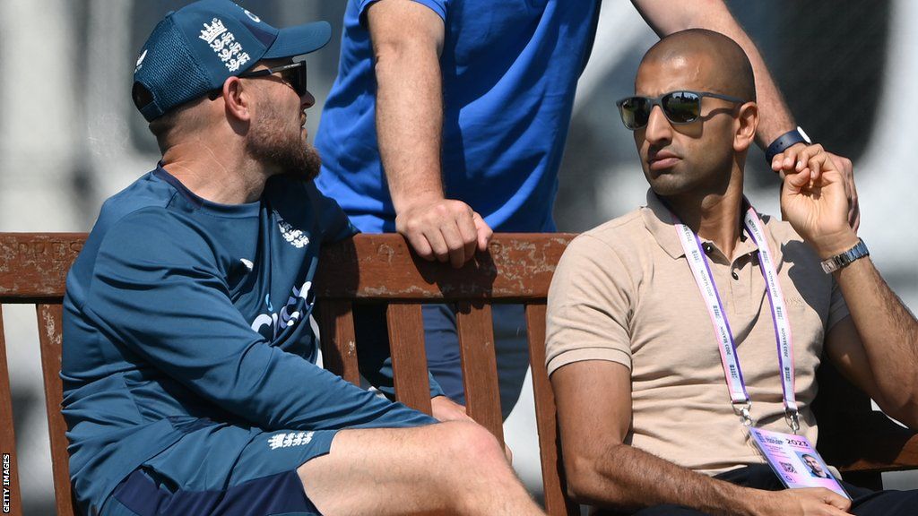 Brendon McCullum and Mo Bobat sit alongside each other on a bench