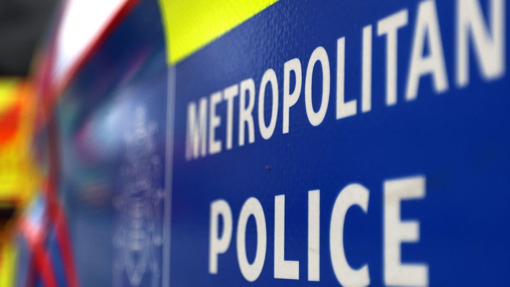 A white and blue sign reading Metropolitan Police.