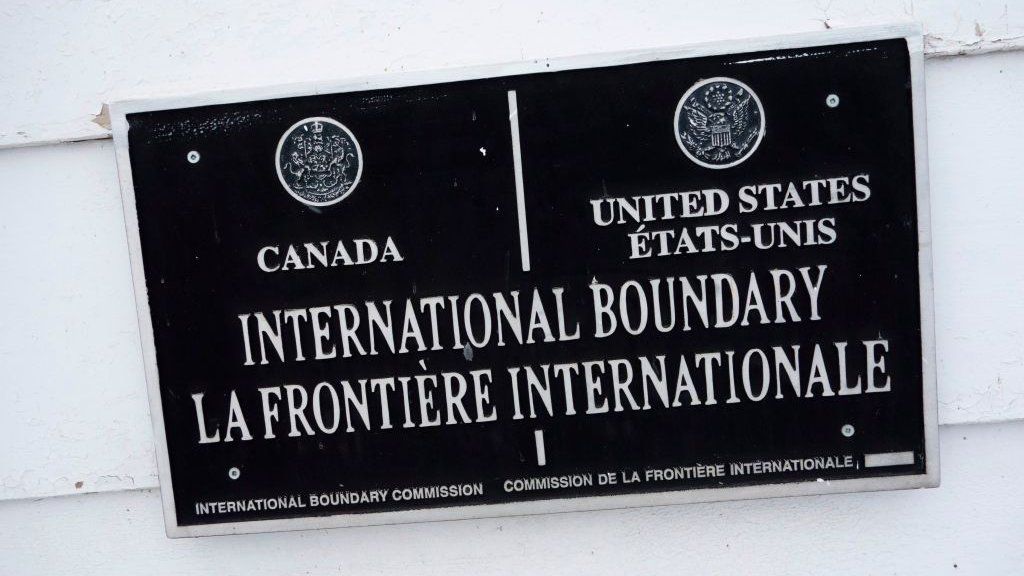 signs mark the US-Canada border