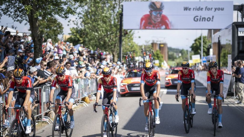Bahrain Victorious team members lead the Gino Mader memorial ride during stage six of the 2023 Tour de Suisse