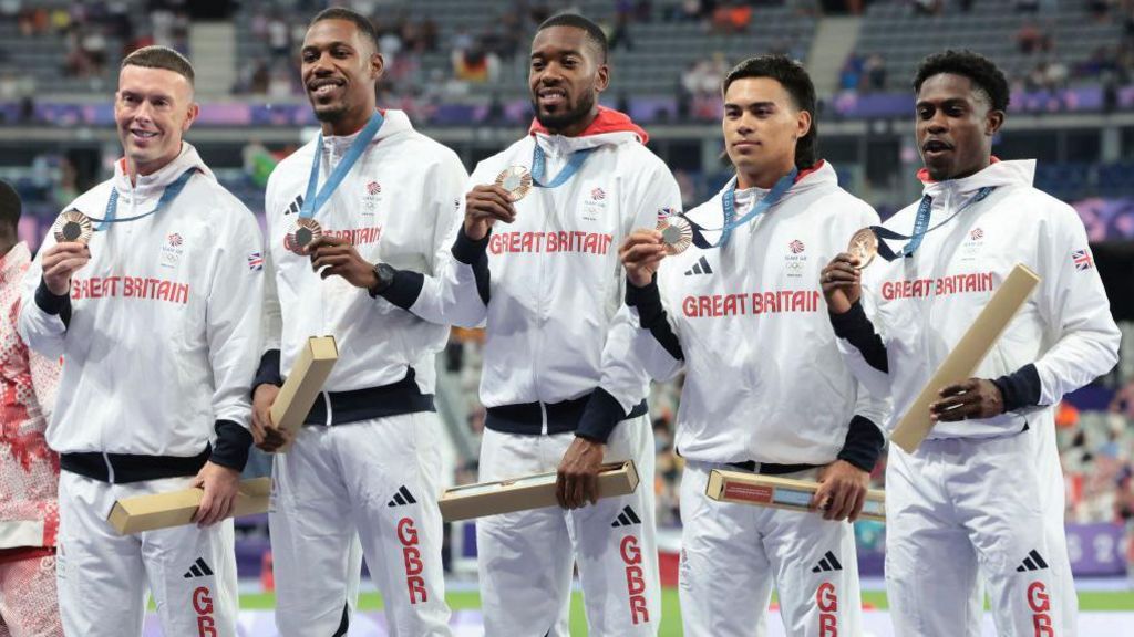 Richard Kilty stood on the podium with Team GB and their bronze medals