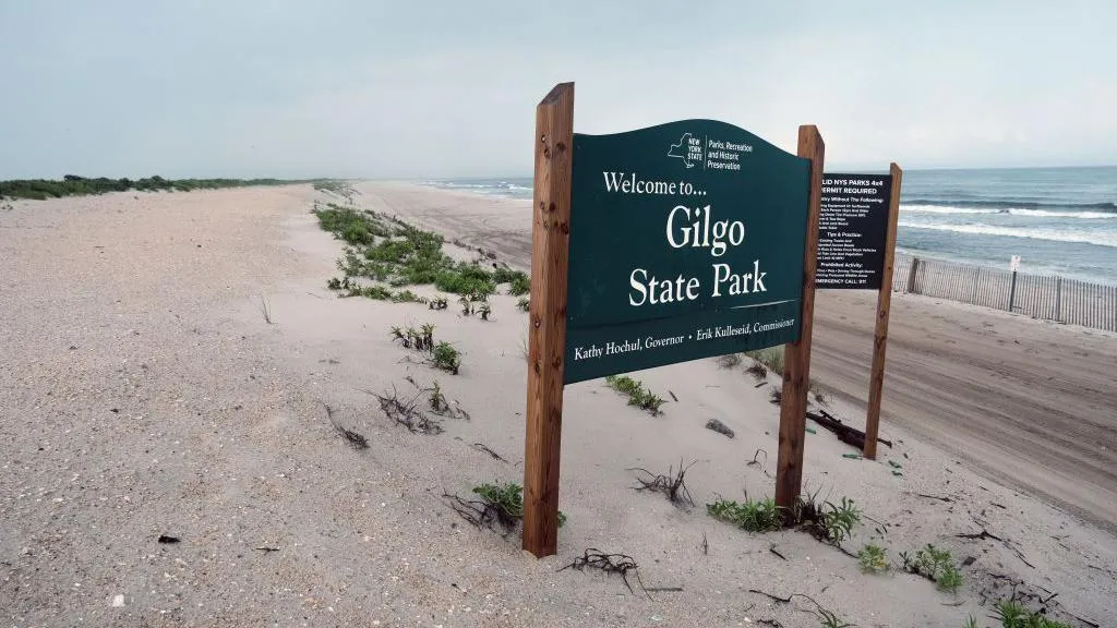 A sign on a beach reads: Welcome to Gilgo State Park