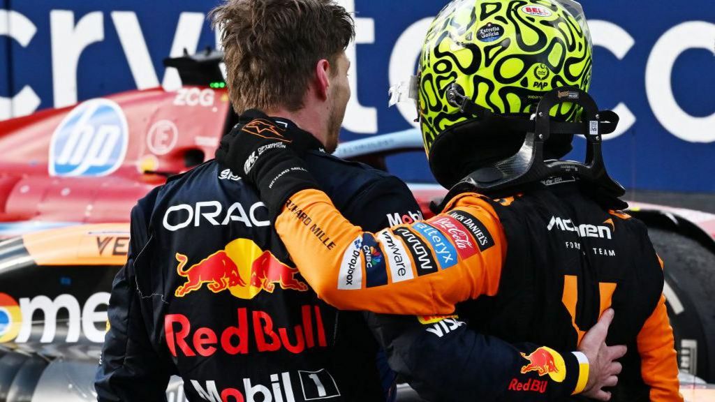 Rear view of Max Verstappen and Lando Norris embracing after the Miami Grand Prix